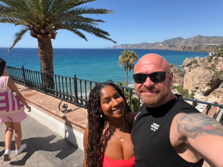 Daniel and his partner by the sea
