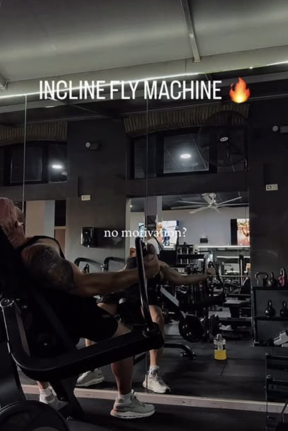 Daniel training on the incline fly machine in the gym