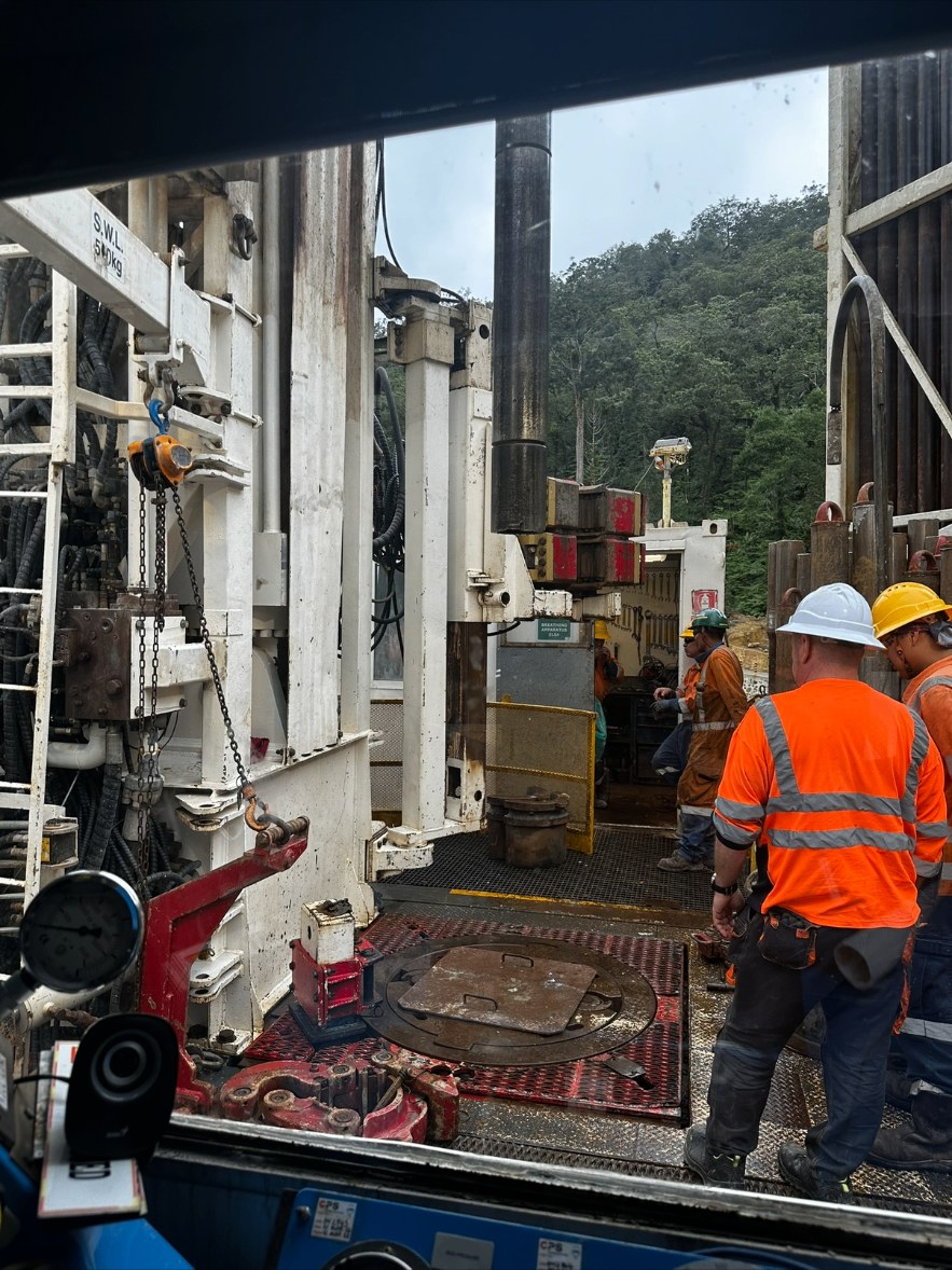 Daniel's drilling rig on rotation, crew in orange hi-vis